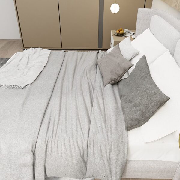 Layered bed linen in soft greys with a folded throw